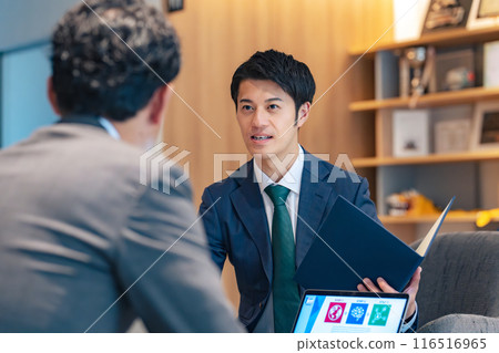 Business people having a business meeting in the lobby Business people having a business meeting in the lobby 116516965