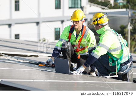 Professional electric engineers survey and inspect solar panels installation on the factory metal sheet roof top, electric engineer team inspecting and check solar cell system. Professional electric engineers survey and inspect solar panels installation on the factory metal sheet roof top, electric engineer team inspecting and check solar cell system. 116517079