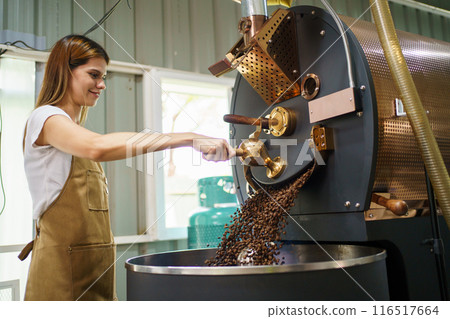 Professional coffee roaster working with modern automated roasting machine in the coffee roasting factory. Food and beverage business concept. 116517664