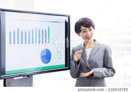 A middle-aged woman in a managerial position having a meeting in the office 116518783