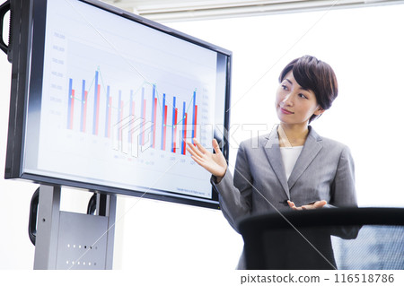 A middle-aged woman in a managerial position having a meeting in the office A middle-aged woman in a managerial position having a meeting in the office 116518786