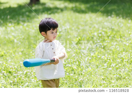 A lively boy playing with a ball in the park 116518928