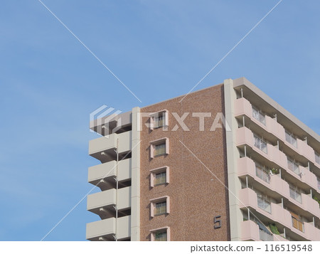 Numbered apartment buildings and blue sky 116519548