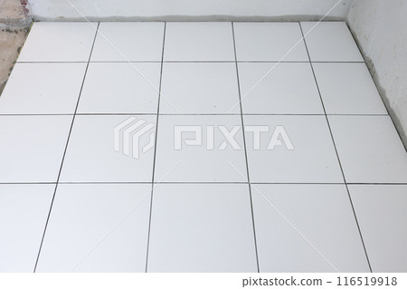 Tile floor under construction in room. 116519918