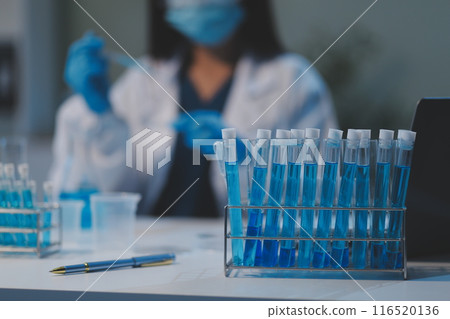 Group of dedicated scientist conduct chemical experiment in medical laboratory, carefully drop precise amount of liquid from pipette into test tube for vaccine drug or antibiotic development. Neoteric Group of dedicated scientist conduct chemical experiment in medical laboratory, carefully drop precise amount of liquid from pipette into test tube for vaccine drug or antibiotic development. Neoteric 116520136