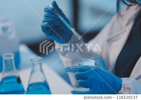 Group of dedicated scientist conduct chemical experiment in medical laboratory, carefully drop precise amount of liquid from pipette into test tube for vaccine drug or antibiotic development. Neoteric Group of dedicated scientist conduct chemical experiment in medical laboratory, carefully drop precise amount of liquid from pipette into test tube for vaccine drug or antibiotic development. Neoteric 116520137