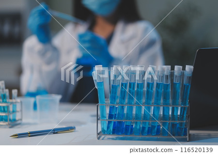 Group of dedicated scientist conduct chemical experiment in medical laboratory, carefully drop precise amount of liquid from pipette into test tube for vaccine drug or antibiotic development. Neoteric Group of dedicated scientist conduct chemical experiment in medical laboratory, carefully drop precise amount of liquid from pipette into test tube for vaccine drug or antibiotic development. Neoteric 116520139