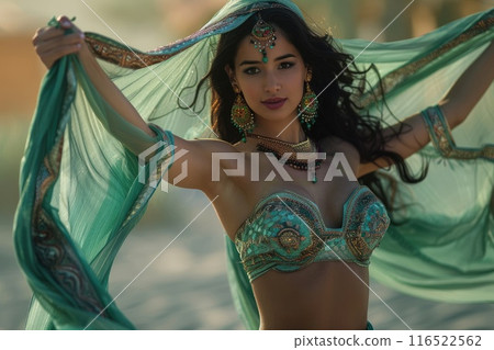 A woman in elaborate green costume poses gracefully against a colorful backdrop. A woman in elaborate green costume poses gracefully against a colorful backdrop. 116522562