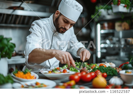 Concentrated male chef garnishing food in kitchen 116522587