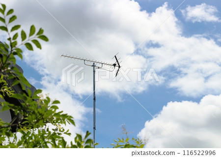 TV antenna, clouds, blue sky, roof reflections TV antenna, clouds, blue sky, roof reflections 116522996