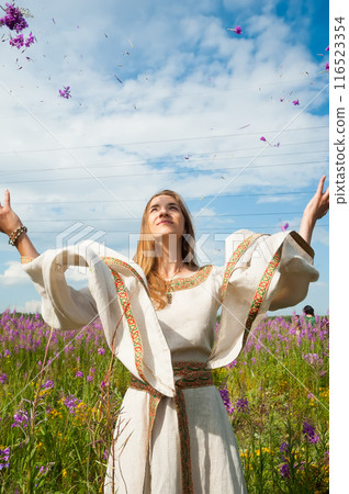 Beautiful woman relaxing on meadow with flowers 116523354