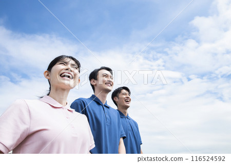 Caregiver group photo with blue sky background Caregiver group photo with blue sky background 116524592