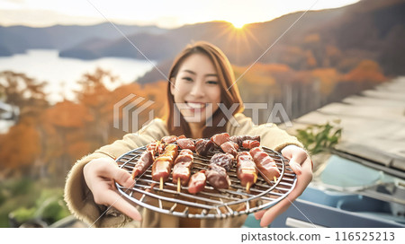 Image of a smiling woman enjoying a barbecue 116525213