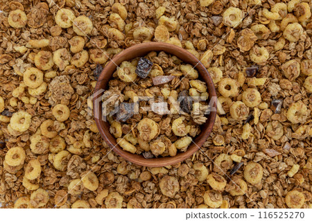 crunchy granola in bowl on muesli background crunchy granola in bowl on muesli background 116525270