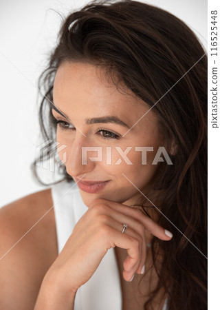 Happy beautiful girl posing in a new hot summer look. Wearing blue jeans and white waistcoat 116525448