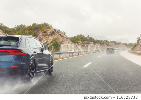 Back tail view of many cars driving fast on wet highway road after rain in Europe. Automobile accident vehicle rush hour collapse. Aquaplaning danger risk. Transportation vacation seasonal stuck Back tail view of many cars driving fast on wet highway road after rain in Europe. Automobile accident vehicle rush hour collapse. Aquaplaning danger risk. Transportation vacation seasonal stuck 116525738