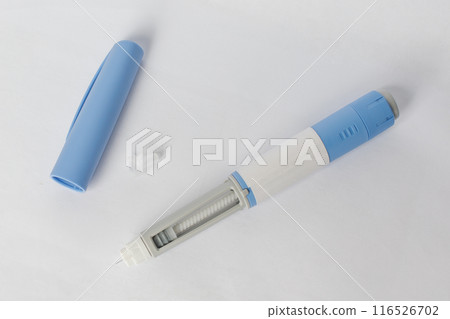 Blue Self injection pen with insulin or semaglutide macro on white background. Blue Self injection pen with insulin or semaglutide macro on white background. 116526702