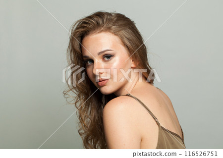 Perfect smiling young adult woman studio photo 116526751