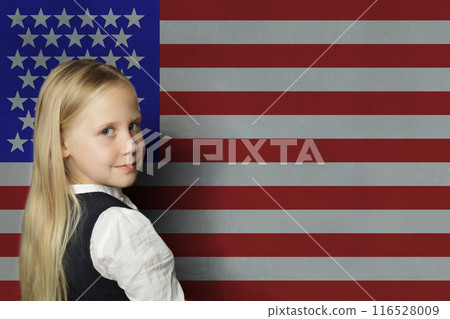 Happy young child girl student in front of USA flag background, US concept Happy young child girl student in front of USA flag background, US concept 116528009