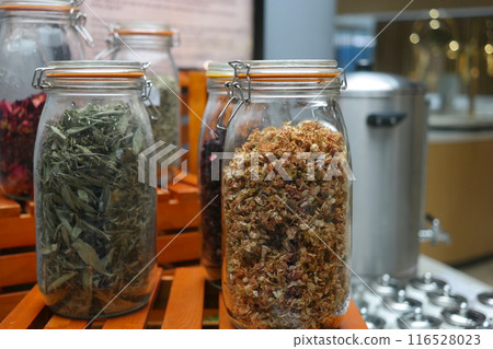 Various kinds of herbal tea in glass jars on wooden pallets 116528023