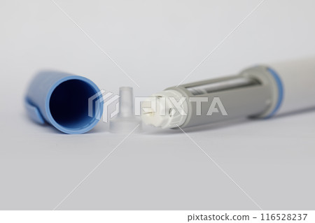 Medication, diabetes and medicine concept. Self injection pen macro on white background Medication, diabetes and medicine concept. Self injection pen macro on white background 116528237