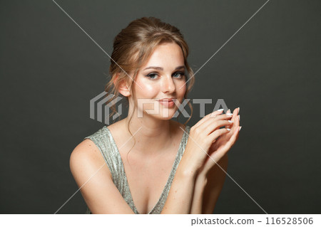 Gorgeous glam woman fashion model with makeup and updo hairstyle on gray studio background 116528506