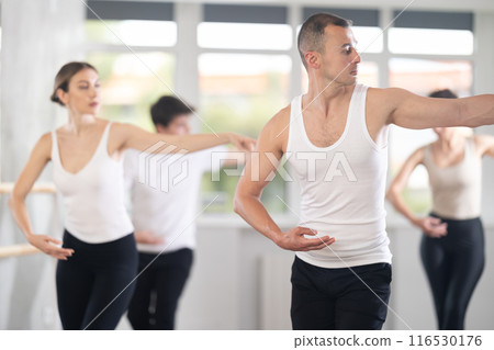 Man participating in group ballet class in choreography studio 116530176