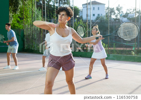 Woman playing frontenis on outdoor pelota court Woman playing frontenis on outdoor pelota court 116530758