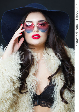 Fashion portrait of young adult woman fashion model with bright make-up and long wavy hair Fashion portrait of young adult woman fashion model with bright make-up and long wavy hair 116531096