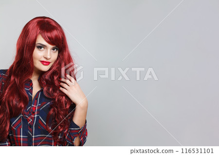 Beauty woman with red hair. Beautiful redhead model with makeup and long curly hair 116531101