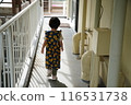 Girl walking down the hallway 116531738