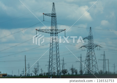 High voltage towers with sky background. Power line support with wires for electricity transmission. High voltage grid tower with wire cable at distribution station. Energy industry, energy saving High voltage towers with sky background. Power line support with wires for electricity transmission. High voltage grid tower with wire cable at distribution station. Energy industry, energy saving 116532753