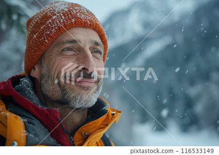 Mature man smiling in snowy mountain scenery 116533149