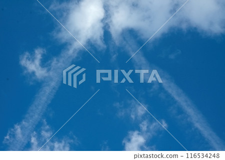Beautiful clouds with contrails in the clear blue sky. 116534248