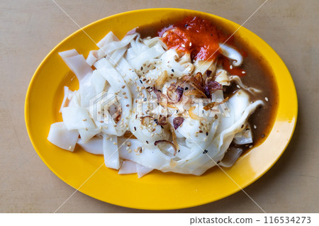 Chee Cheong Fun or Rice noodle roll served with sauces, and a sprinkle of sesame and shallot is popular Chinese food in Malaysia 116534273