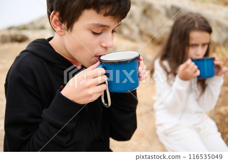 Children enjoying warm drinks outdoors on a cool day 116535049