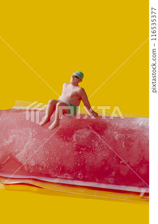 miniature man sitting on a freeze pop 116535377