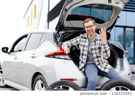 Car mechanic working in car showroom and changing wheel alloy tire. Repair or maintenance auto service. Car mechanic working in car showroom and changing wheel alloy tire. Repair or maintenance auto service. 116535843