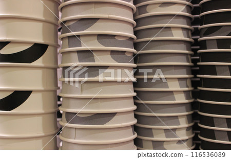 Painted paper cups lined up in columns arranged by color for coffee of different strengths 116536089