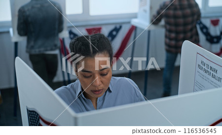 African American woman comes to vote in booth African American woman comes to vote in booth 116536545