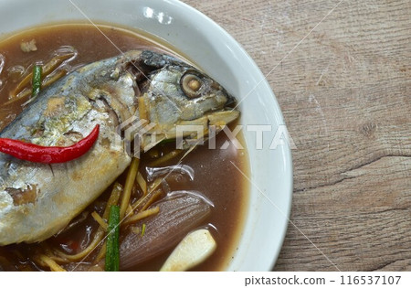 spicy boiled mackerel with chili and ginger in soup on plate 116537107