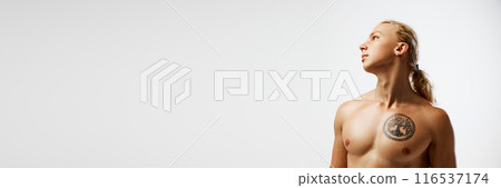 Banner. Bare chested, young man posing looking away against white studio background with negative space to insert your text. Banner. Bare chested, young man posing looking away against white studio background with negative space to insert your text. 116537174