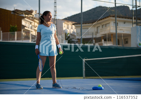 Woman plays tennis on the court 116537352