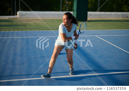 Woman plays tennis on the court 116537359