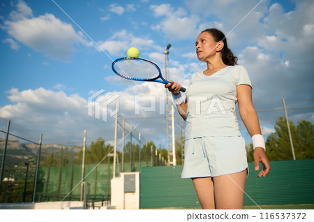 Woman plays tennis on the court Woman plays tennis on the court 116537372