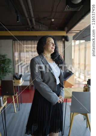 60s stylish, confident mature businesswoman, female leader, middle older aged company ceo director, experienced senior female professional, business coach team leader in modern office. 116537456