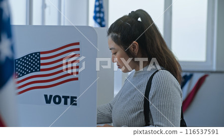 Multi ethnic American citizens come to vote in booth 116537591