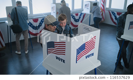 Caucasian man with son enters the voting booth to fill out ballot paper 116537629