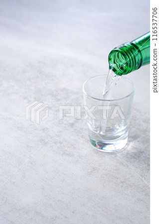 Pouring chilled Korean soju (traditional Korean distilled alcohol) into a glass 116537706