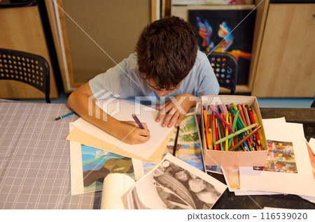 Child drawing and painting in art class with colorful pencils Child drawing and painting in art class with colorful pencils 116539020